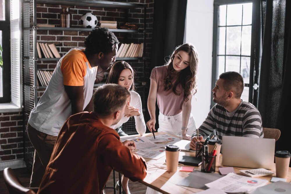 A diverse team collaborating on projects in a modern office setting.