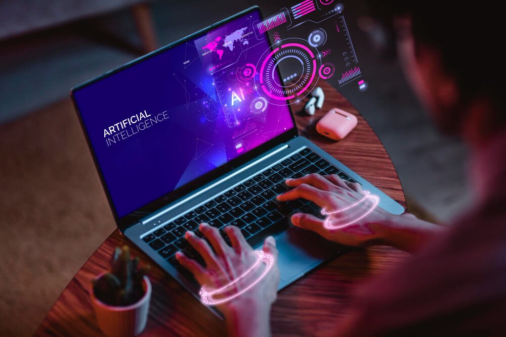 A man sitting at a desk using a laptop with a virtual reality interface.